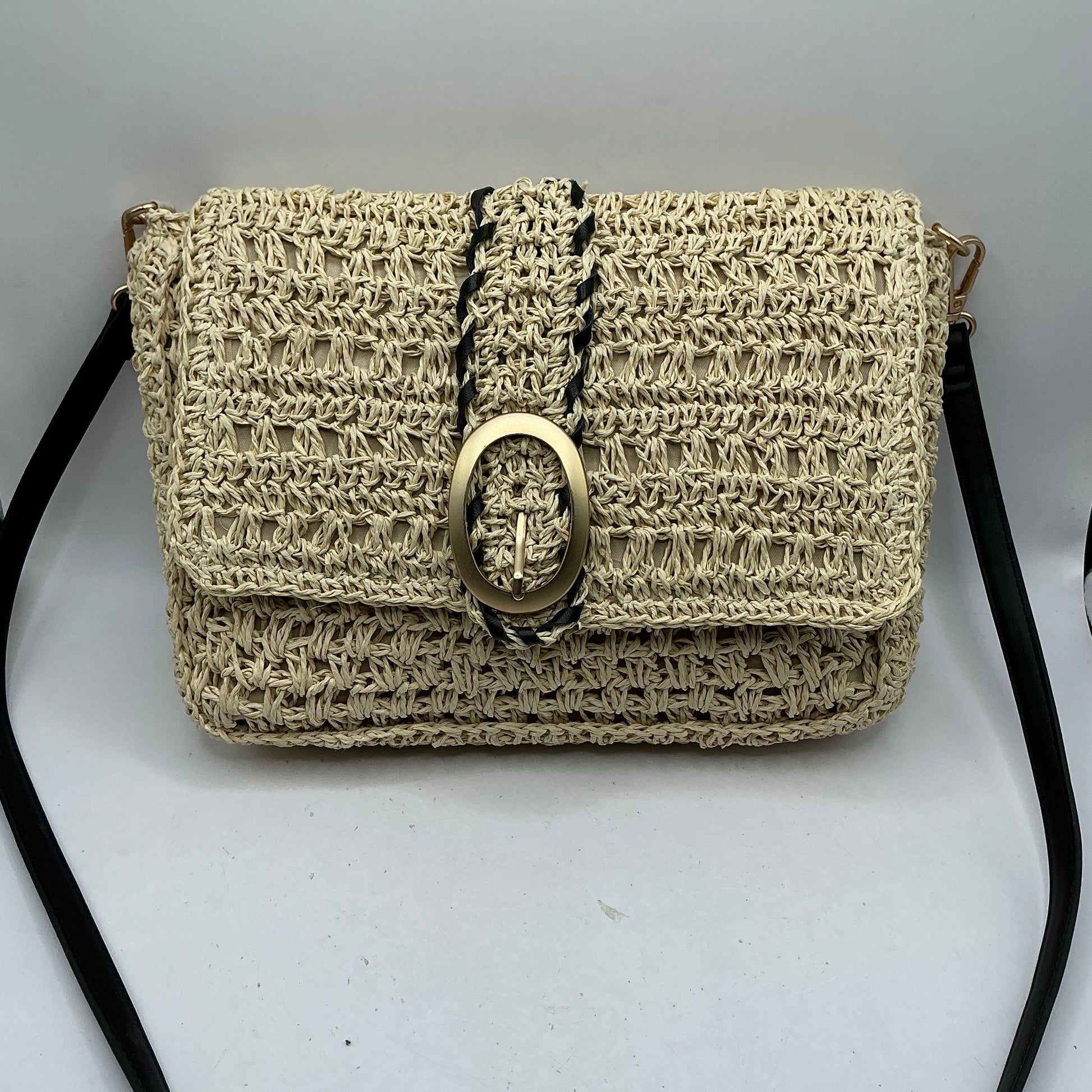 Natural straw handbag with faux leather handle and trim