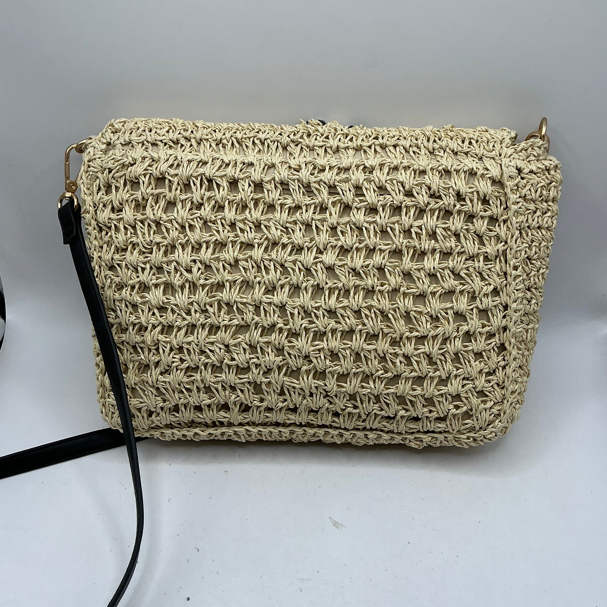 Natural straw handbag with faux leather handle and trim