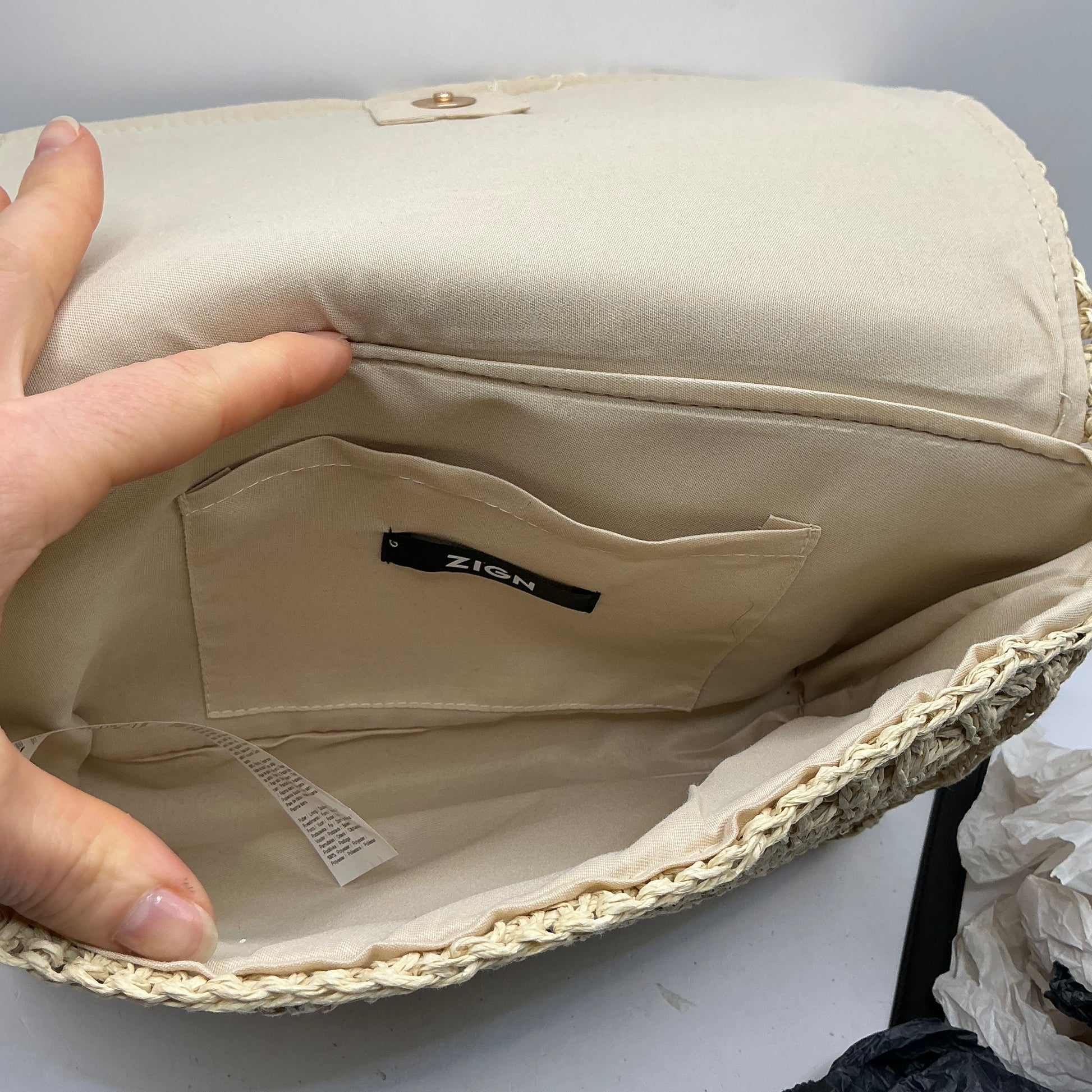 Natural straw handbag with faux leather handle and trim