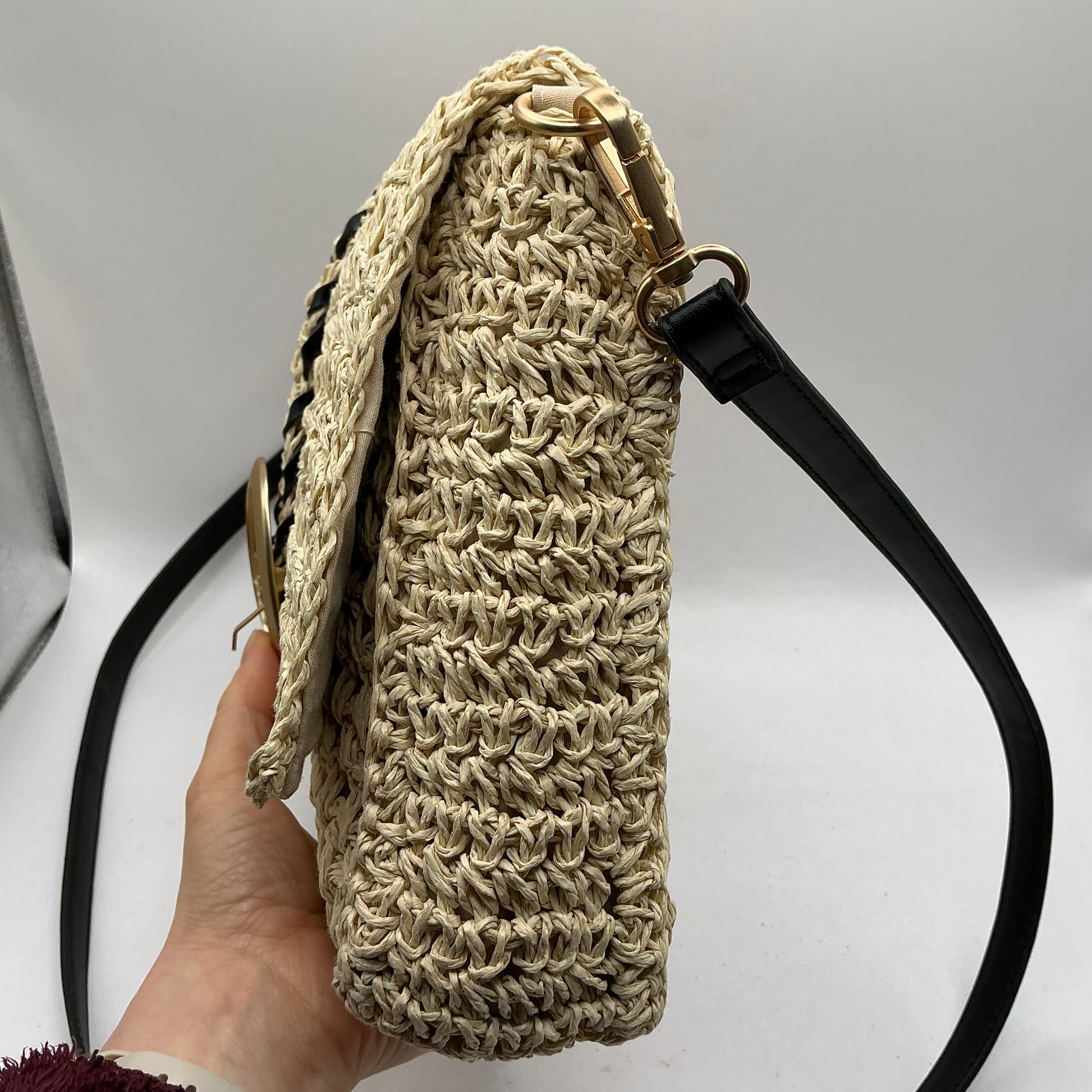 Natural straw handbag with faux leather handle and trim