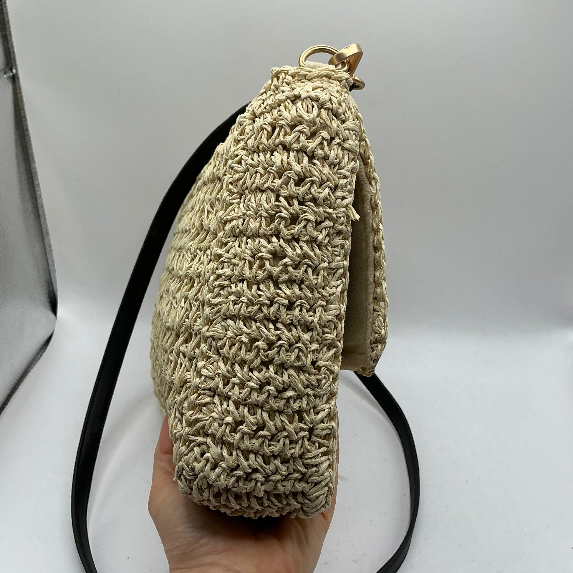 Natural straw handbag with faux leather handle and trim