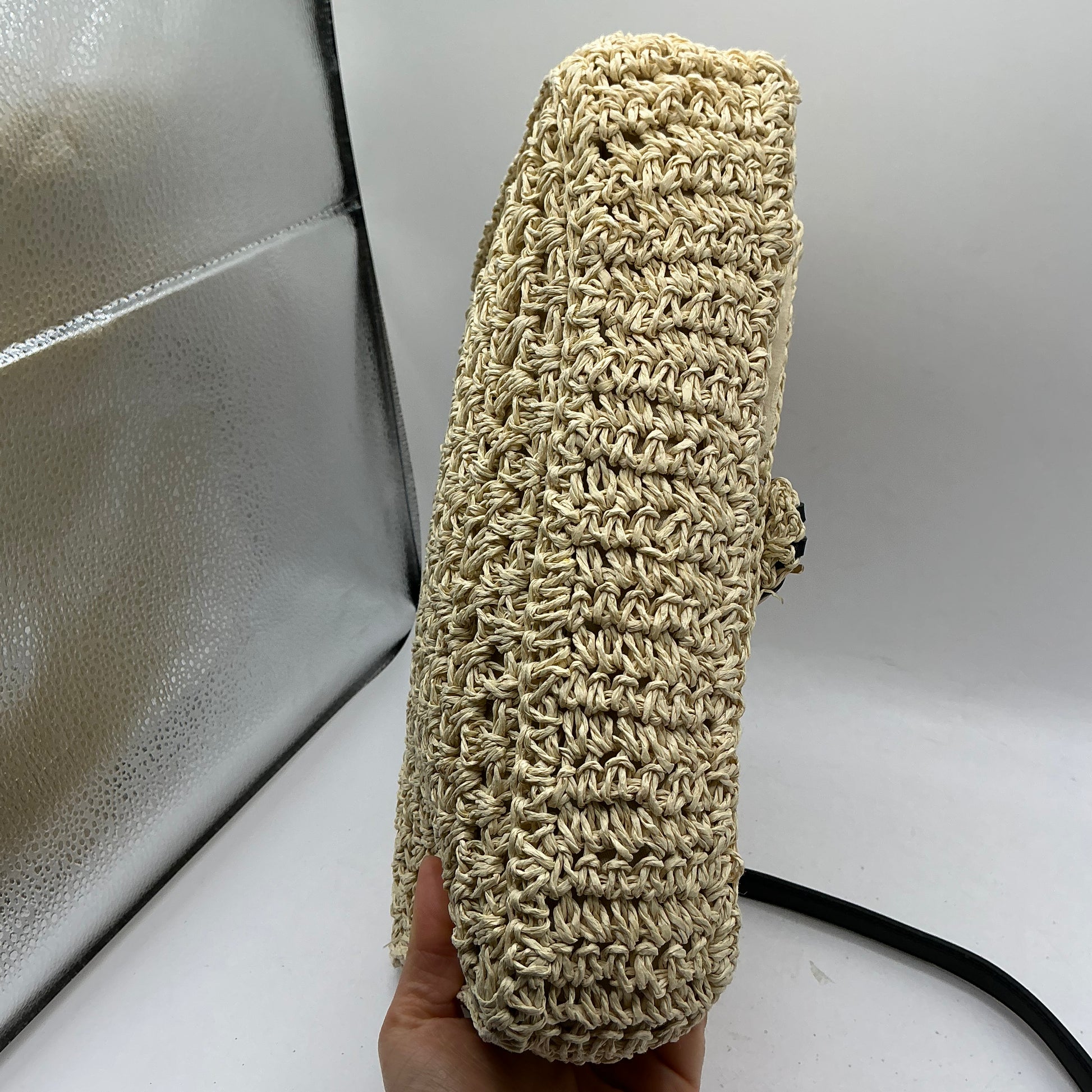 Natural straw handbag with faux leather handle and trim